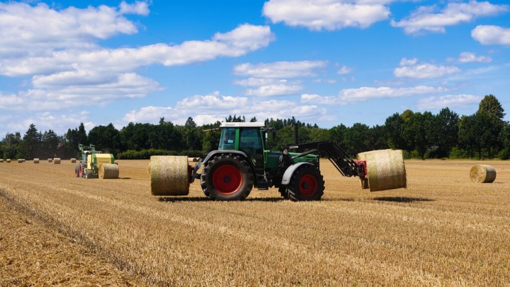 Tractors operating in a wheat field during harvest season in Dassendorf, Germany.